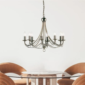 Bronzen kroonluchter met acht armen boven ronde eettafel in moderne eetkamer