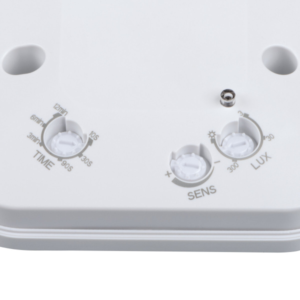 Witte bewegingssensor met draaiknoppen voor tijd, gevoeligheid en lichtsterkte.