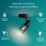 Zwarte plafondspot met cilindrische kap van gerookt glas en zichtbaar filament