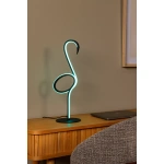 Flamingo tafellamp met neonlicht op houten bureau naast grijze stoel.