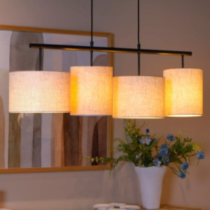 Beige hanglamp met vier stoffen kappen boven eettafel in warme verlichting