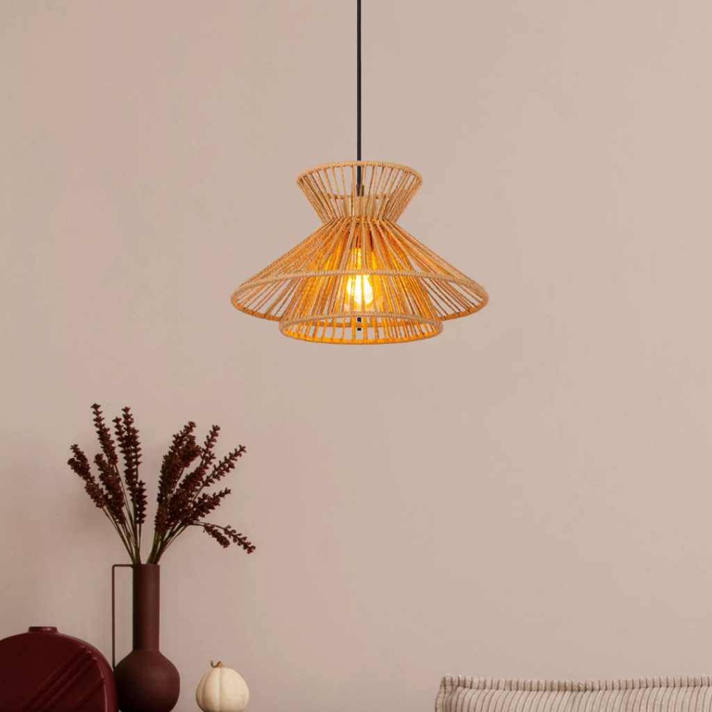 Hanglamp van naturel rotan met warme gloed boven een moderne eettafel