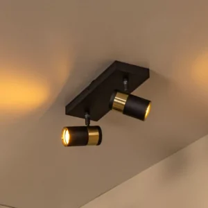 Zwarte en gouden plafondspot met twee verstelbare lichtpunten in warme verlichting